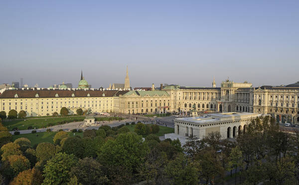 Elevated view of the Hofburg with the Heldenplatz from the Burgring with treetops in the foreground